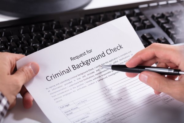 background check service truthfinder cost price completing request for criminal background check with pen on paper
